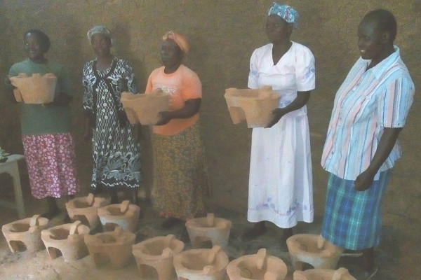 The women showing off their recently made clay liners
