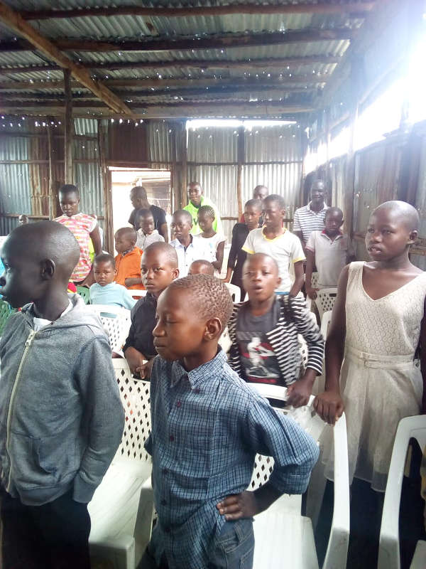 Children standing in a classroom